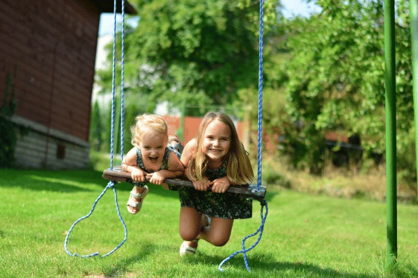 Two girls on swing