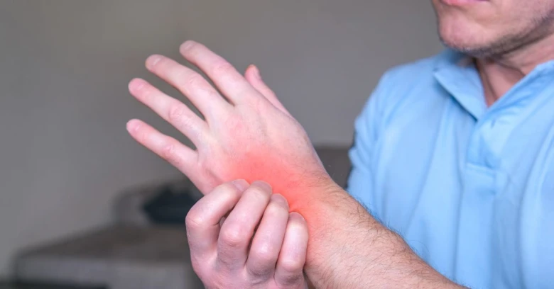 Man holding wrist in pain