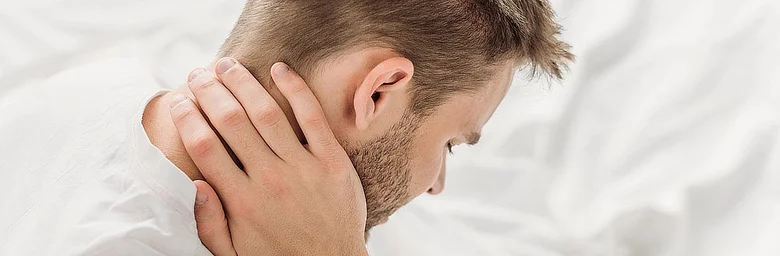 Man holding neck in pain