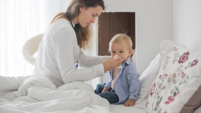 Doctor treating child's throat