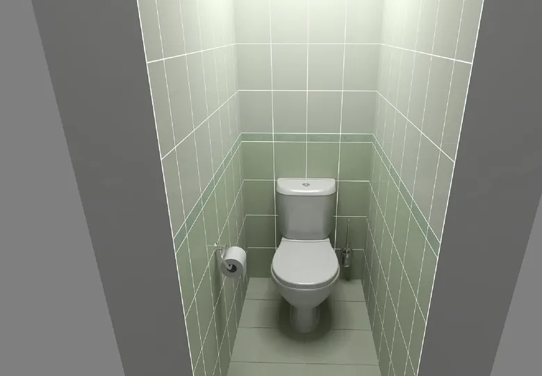 Bílá toaleta v malém WC s dlažbou na stěnách.