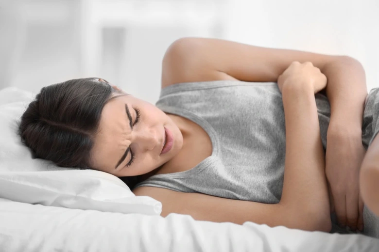 Woman in pain on bed